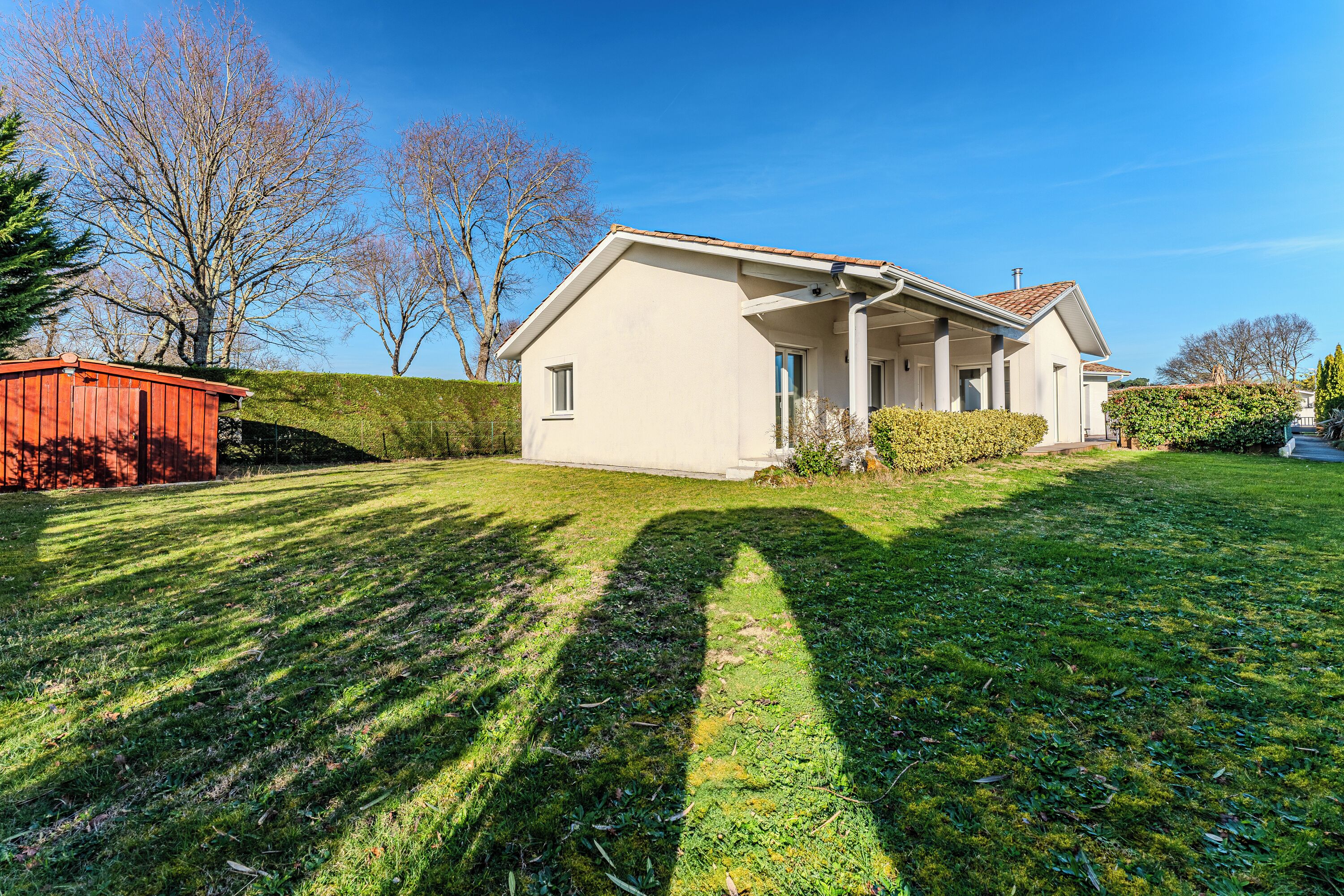A single-story house with a sloped roof, a front porch, and a well-maintained lawn.