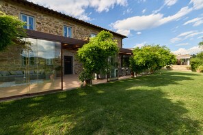 A stone building with a glass conservatory, a grassy lawn, and a clear sky. - Villa Noce by My Villa Collection (Barberino Tavarnelle)