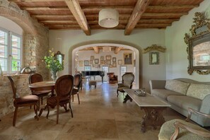 A spacious living area with a dining table, chairs, a sofa, and a fireplace. - Villa Noce by My Villa Collection (Barberino Tavarnelle)
