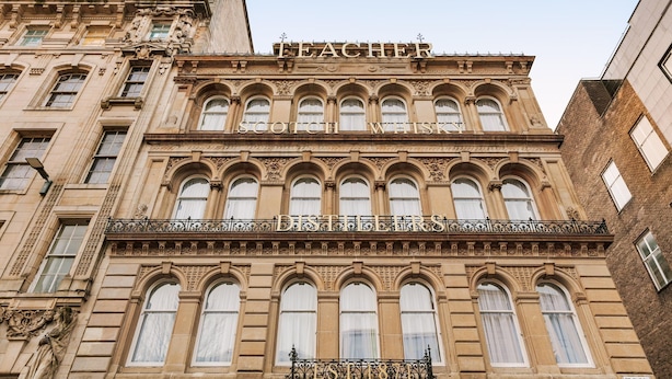 A historic building with ornate architectural details, including arched windows and decorative stonework.