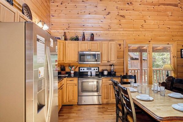 Your fully-equipped kitchen invites relaxed mornings brewing coffee and preparing meals in cozy, wood-lined comfort. Step through the doors to your private deck. - Luxury Resort*Close to Dollywood*Sleeps 10 (Pigeon Forge)