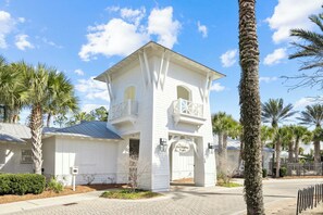 A white building with a balcony and a sign reading "The Gathering Place". - New Listing Naturewalk: Private Heated Pool & Spa. EVCharger, Golf Cart & Bikes. (Santa Rosa Beach)