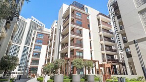 A multi-story residential building with balconies, large windows, and a clear sky. - Silkhaus Stylish 1bdr With Pool Balcony Dubai Creek Harbour (Dubai)