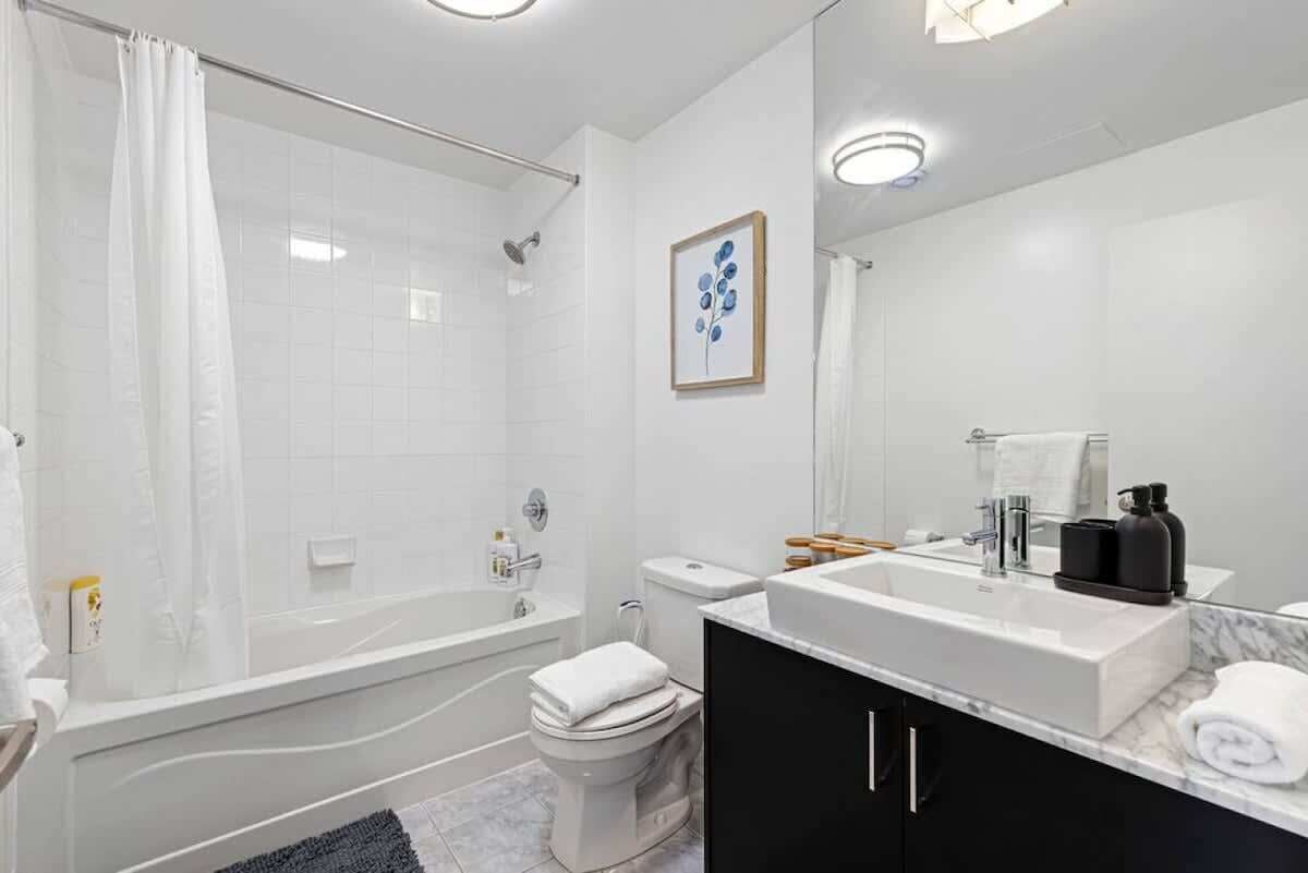 Clean bathroom with a shower + bathtub combination.