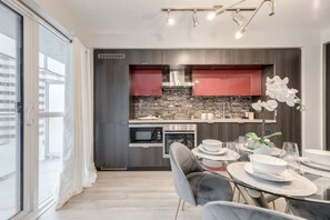 Kitchen and dining area - Stunning 1BR and Den Sleeps 6  Steps From CN Tower (Toronto)