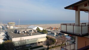 A coastal view with a control tower, buildings, and a beach. - CV020 – Cervia, penthouse with stunning sea view (Cervia)