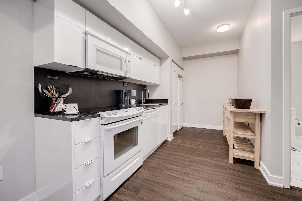 Fully stocked kitchen with complete set of cookware.