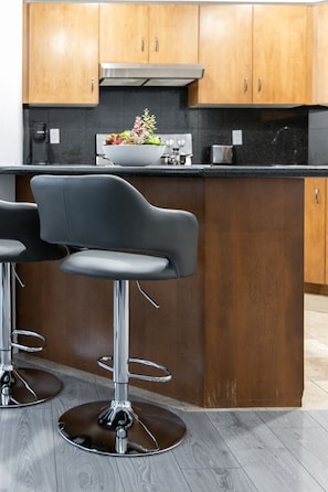 The full-stock kitchen boasted gleaming stainless steel appliances, ample counter space, and every culinary tool imaginable, ensuring every meal was a gourmet delight. - Modern 1BR/1BA condo near Downtown with City Views (Toronto)