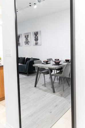 The dining area, adjacent to the kitchen, featured an elegant table surrounded by comfortable chairs - Modern 1BR/1BA condo near Downtown with City Views (Toronto)