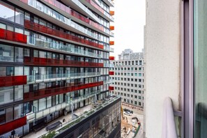 The Juliet balcony offered a charming view of the bustling city streets below, framed by ornate wrought-iron railings, inviting moments of quiet contemplation amidst the urban rhythm. - Modern 1BR/1BA condo near Downtown with City Views (Toronto)
