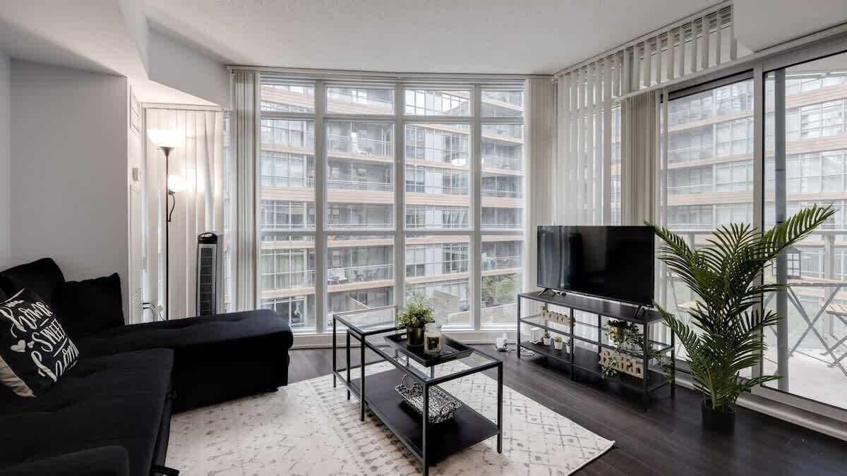Bright living space complete with a sofa bed and smart TV.