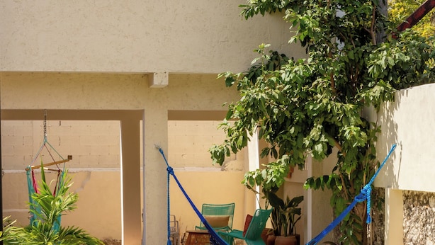 A poolside area with a hammock, lounge chairs, and a small pool. - Casa Kolibrí - 8 Bedrooms + Pool + Outdoor Kitchen + Coworking (Mérida)