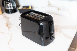 A black toaster on a marble countertop. - Stay in University Heights Shops, Dining, Park (San Diego)