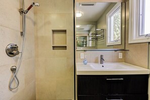 A bathroom with a shower, sink, and dark wooden cabinet. - Furnished Apartment 2bd-2ba Special 4800 / Month in Santa Monica Like a House (Santa Monica)
