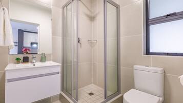 Regadera, secadora de cabello, toallas, papel de baño