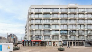 Een meerlaags hotel met een moderne gevel, voorzien van balkons en grote ramen.