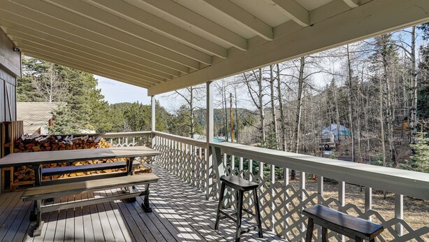 A wooden deck with a covered area, a picnic table, and a bench. - Steps to Lake Isabel & Trails! Mtn-View Hideaway (Rye)