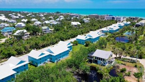 A resort with multiple buildings, a beach, and a clear view of the ocean. - Coming soon brand new condos on the West end of Sanibel! Deeded beach access! (Sanibel)
