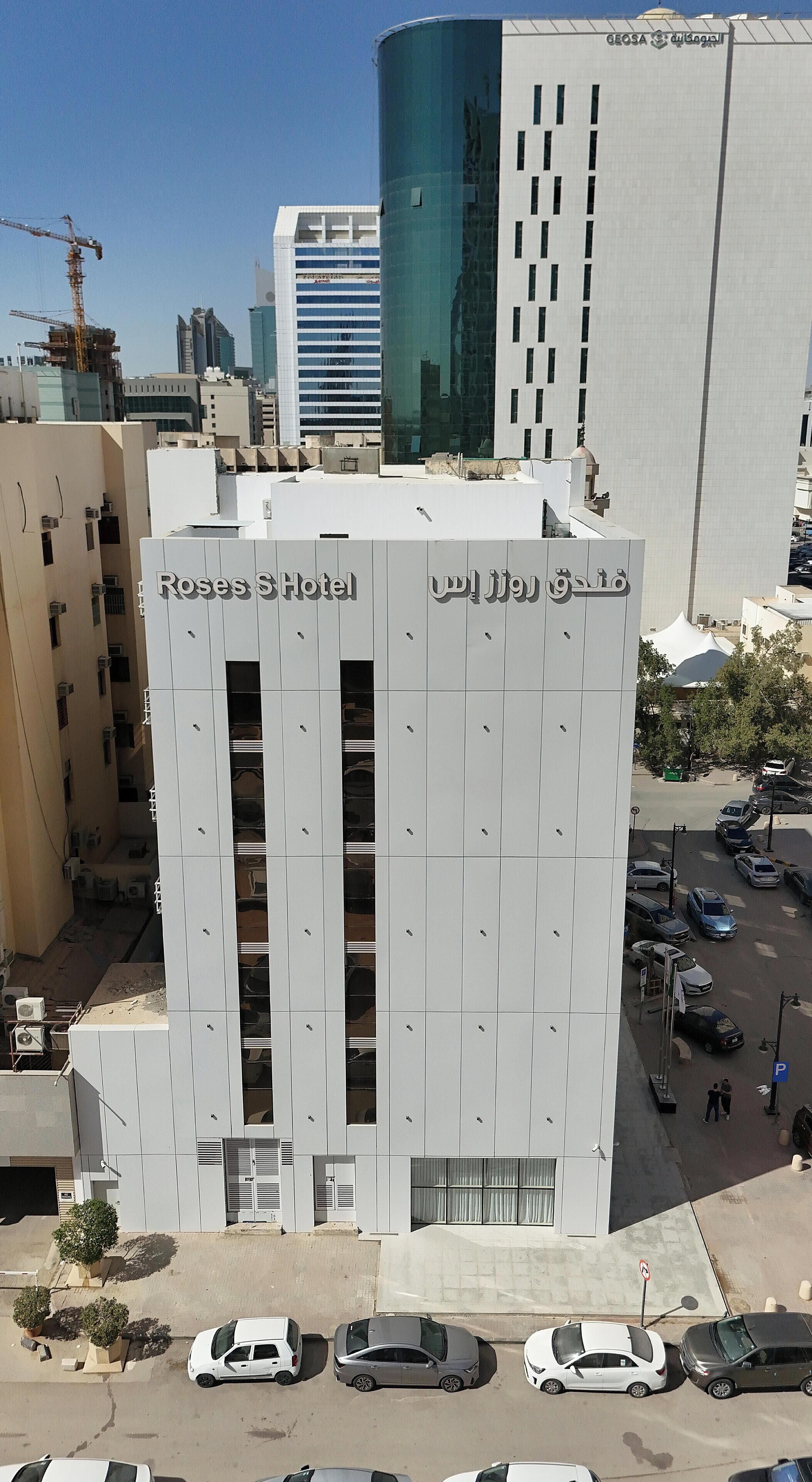 A hotel with a modern facade, multiple floors, and a prominent entrance.