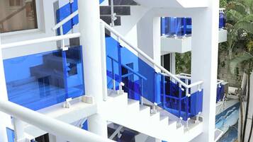 A multi-level building with glass railings and white structural elements.