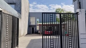 A gated entrance to a building with a sign indicating a guest house. - Affordable studio type guest house (Dagupan)