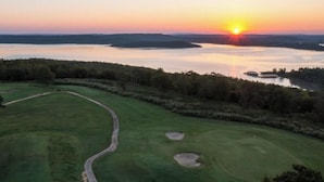 A golf course with a path, water body, and forested area. - Walk to Lake • 🔥Fire Pit • Pets Welcome 🐾.             + golf ⛳️ (Canadian)