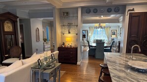 A spacious living area with a marble island, a dining table, and a kitchen in the background. - Perfect location - renovated home w/2 master suites & exceptional outdoor space. (Washington)