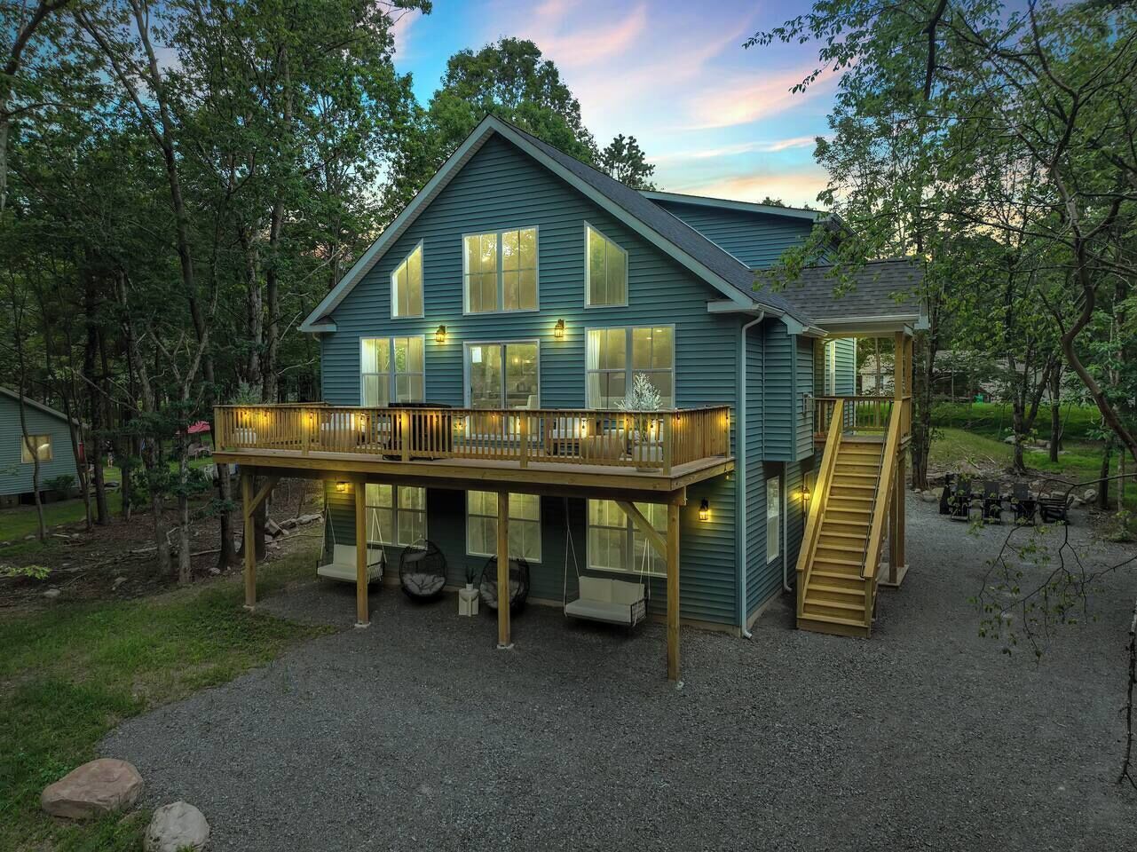 A two-story house with a balcony, a staircase, and a deck area.
