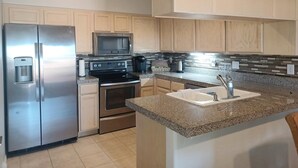 A modern kitchen with stainless steel appliances, a granite countertop, and wooden cabinets. - Sparkling Clean 'Javelina Hideaway' in Beautiful Fountain Hills (Fountain Hills)