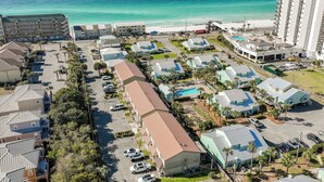 A coastal hotel with multiple buildings, a parking lot, and a view of the beach and ocean. - Prime Location/2 Bdr/Sleeps 7/Pet friendly (Santa Rosa Beach)