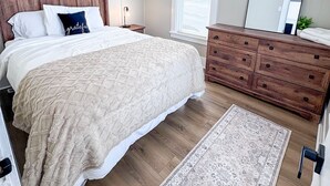 A bedroom with a bed, dresser, mirror, and a rug. - Serene 1-bedroom house in welcoming Slippery Rock (Slippery Rock)