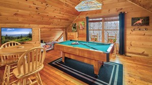 A wooden cabin with a pool table, chairs, and a television. - FALL FOLIAGE RETREAT! 1BR+Loft Cabin w/Hot Tub & Arcade (Sevierville)