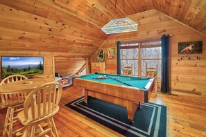 A wooden cabin with a pool table, chairs, and a television. - FALL FOLIAGE RETREAT! 1BR+Loft Cabin w/Hot Tub & Arcade (Sevierville)