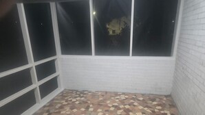 A room with a tiled floor, white brick walls, and large windows. - Serene vintage 3b/2ba  home with AC. Medical professions MD, NP, RN are welcome. (Valdosta)