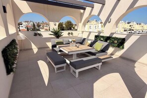 An outdoor patio with a sofa set, a table, and planters. - 3 Bed Villa - Sleeps 6 - Private Pool - Parking (ciudad, alicante)
