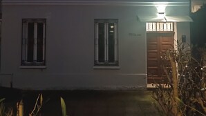 A two-story building with a flat roof, a front door with a small overhang, and two windows on the ground floor. - MTB b&b (Alfonsine)