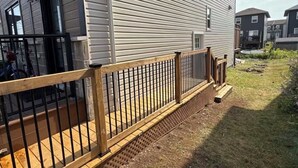 A residential building with a wooden deck and a brick pathway leading to the entrance. - Cozy Private Basement Suite (Halifax)