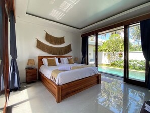 A modern bedroom with a wooden bed, a nightstand, a lamp, and a view of a swimming pool. - Ubud-Villa 2ch & piscine privée calme et paisible (lodtunduh)