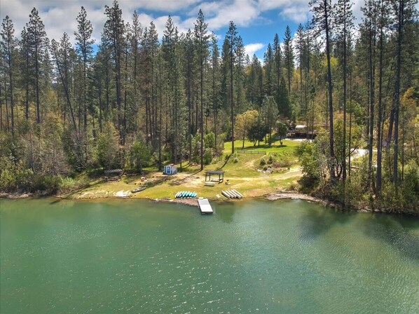 A lakeside property with a dock, a small cabin, and a gazebo. - Lakefront Cabin w/ Dock, Kayaks & Full Kitchen (Nevada City)