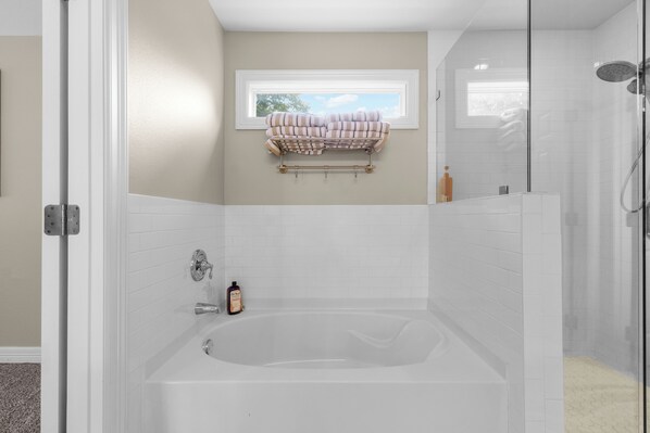 A bathroom with a bathtub, a window, and a towel rack. - Cozy home in Ft Worth, walk to Dickies Arena & Will Rogers Coliseum horse show (Fort Worth)
