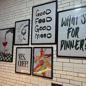 A wall with various framed signs related to food and dining. - Smart 3-bedroom building in charming Lekki with AC for relaxing stays (Lekki)
