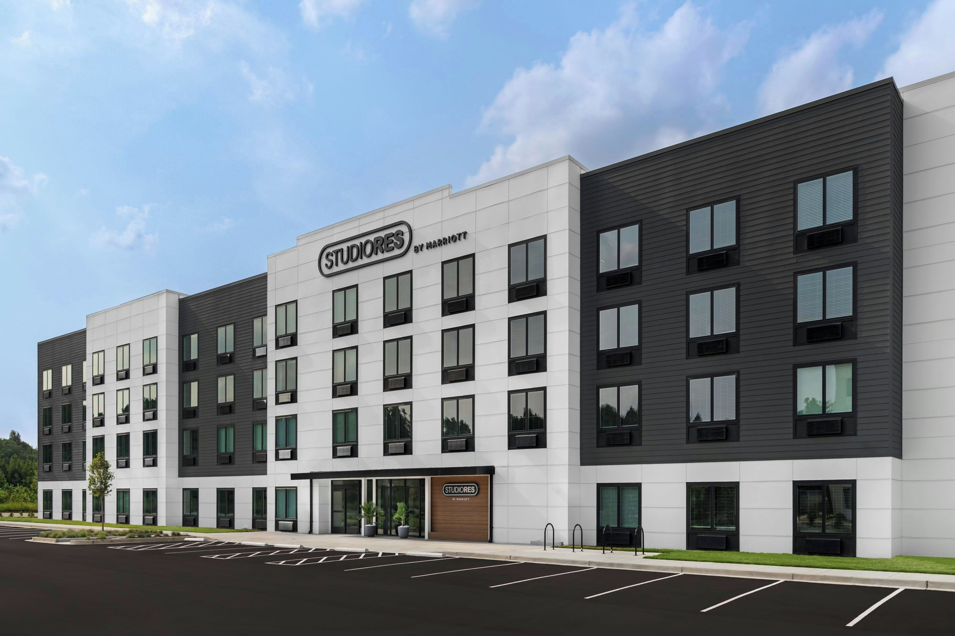 A multi-story hotel with a modern design, featuring a prominent 'STUDIORES BY MARRIOTT' sign.