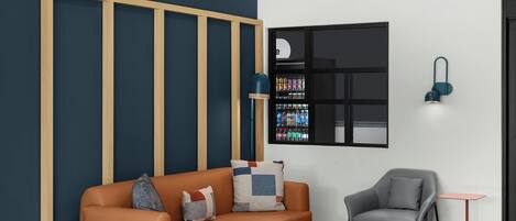 A modern living room with a sofa, two side tables, a grey armchair, and a small table.