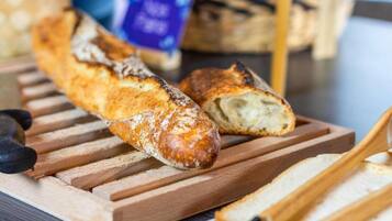 A baguette on a wooden cutting board.