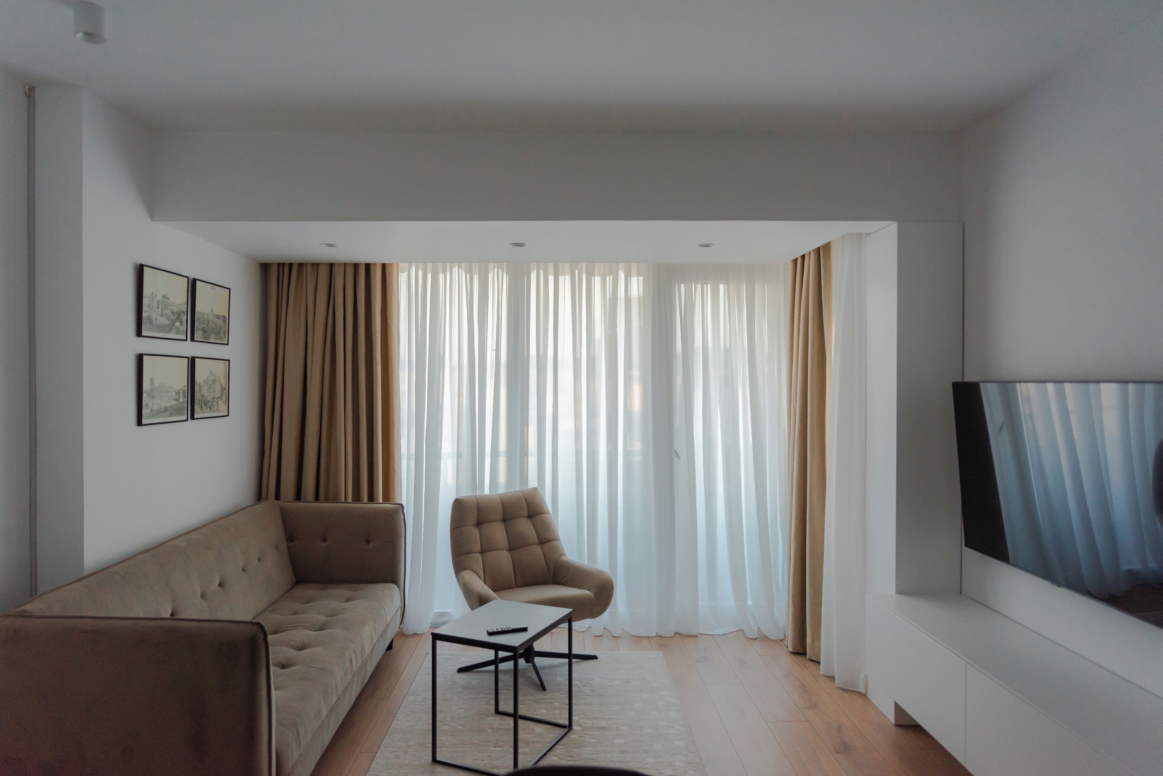 A modern living room with a sofa, armchair, and a coffee table.