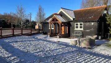 A wooden house with a sloped roof and a porch.