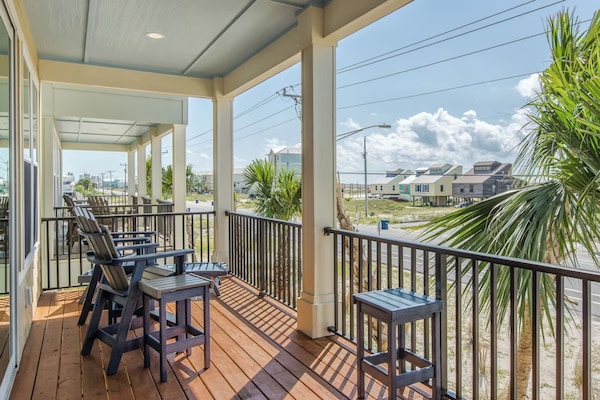 Beautiful covered front porch with Gulf views and plenty of seating