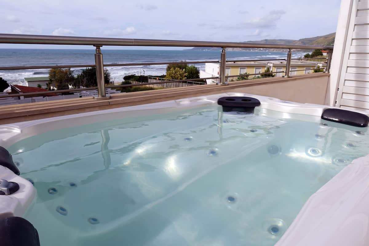 A hot tub with a view of the ocean.