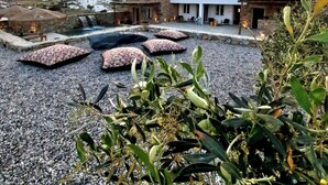 A rooftop terrace with a view of a modern building, a pool, and surrounding landscape. - Mykonos Dot - Art Homes (Ano Mera)