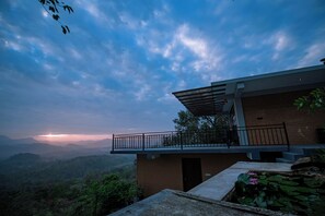 Un bâtiment moderne doté d’un balcon donnant sur un paysage montagneux.